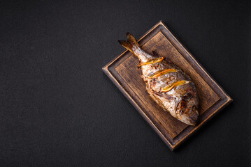 Delicious dorado baked on the grill with salt, spices and herbs