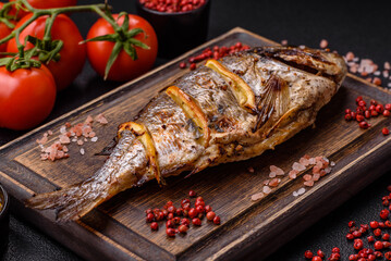 Delicious dorado baked on the grill with salt, spices and herbs