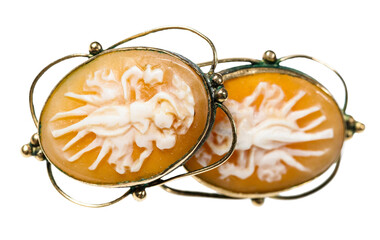 antique earrings with cameo carved on natural see shells close up isolated on white background