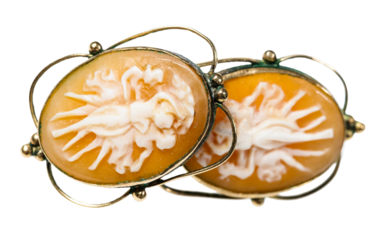antique earrings with cameo carved on natural see shells close up isolated on white background