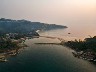 Aerial drone view small Koh Ma island, Ko Phangan Thailand. Exotic coast panoramic landscape, Mae Haad beach, summer day. Sandy path between corals. Vivid seascape, mountain coconut palms from above.