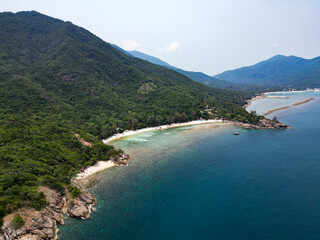 Aerial drone view small Koh Ma island, Ko Phangan Thailand. Exotic coast panoramic landscape, Mae Haad beach, summer day. Sandy path between corals. Vivid seascape, mountain coconut palms from above.