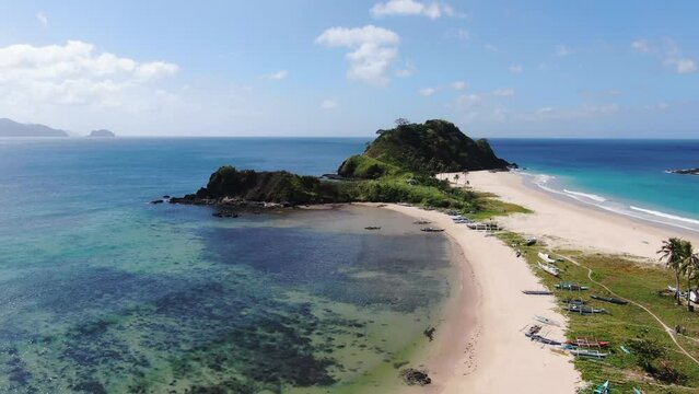 Aerial view of a beach with an island surrounded by water and sky El Nido Nacpan Twin Beach Palawan Philippines Drone