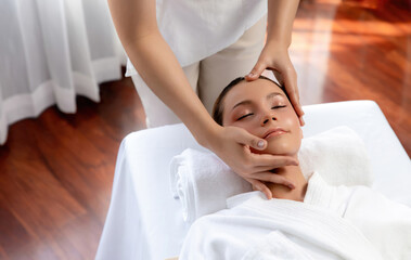 Caucasian woman enjoying relaxing anti-stress head massage and pampering facial beauty skin...