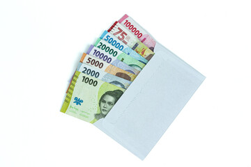 Indonesian rupiah currency. Stack of Rupiah or IDR banknotes inside white envelope isolated on white background