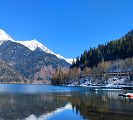 Lake Ritsa in February. Abkhazia. Landscape with a mountain lake in early spring