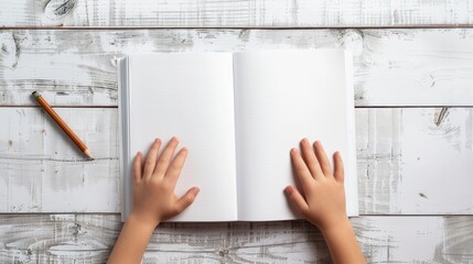  kids hands on blank book on white tab;e - obrazy, fototapety, plakaty