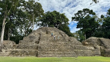 A temple ruins with tourists in San Ignacio Cahak Pech Archaeological Site in Belize