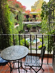View of the courtyard from the terrace with table and chair above in Guatemala