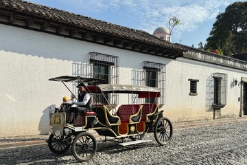 A motor carriage driving on the cobblestone street in Antigua, Guatemala - obrazy, fototapety, plakaty