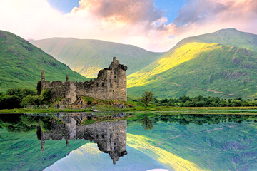 Beautiful Kilchurn Castle on Lock Awe in the highlands of Scotland at sunset with reflections - 765848451