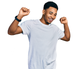 Young african american man wearing casual white t shirt dancing happy and cheerful, smiling moving casual and confident listening to music