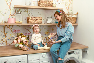 Mom showing her daughter bunny toy. Eastern