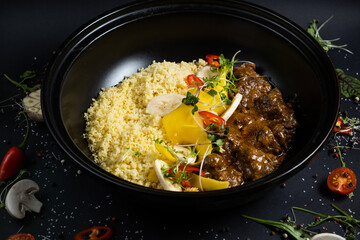 Traditional tajine dishes, couscous and fresh salad on rustic wooden table. Tagine lamb meat and pumpkin. Top view. Flat lay