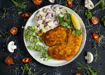 Homemade breaded german weiner schnitzel with potatoes.