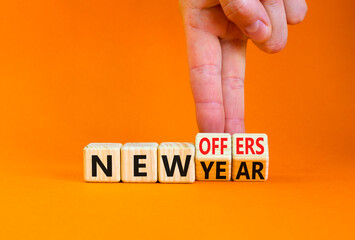New year and offers symbol. Concept word New year New offers on beautiful wooden cubes. Beautiful orange table orange background. Businessman hand. Business new year and offers concept. Copy space.