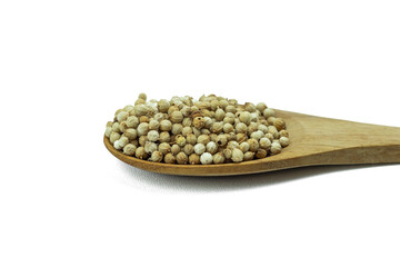 Close-up of Coriander seeds on wooden spoon isolated on white background