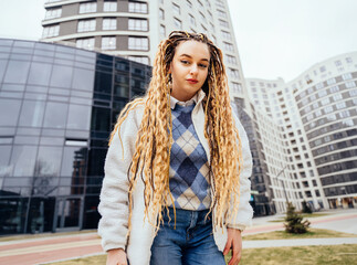 Young teenager hipster girl woman smiling cunningly happy walking at the city.