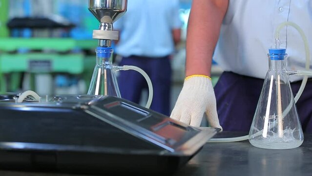 Science experiment close up automatic machine scientist mixing chemicals conducting experiment science experiment in a beaker flask titration with colorful pink chemical liquid in laboratory medicine