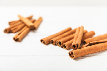 Cinnamon sticks on a textured wooden background. Cinnamon roll. Spicy spice for baking, desserts and drinks. Fragrant ground cinnamon. cinnamon powder Close-up. Place for text. copy space