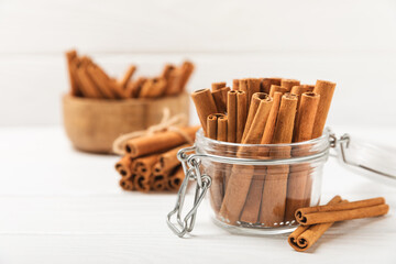 Cinnamon sticks on a textured wooden background. Cinnamon roll. Spicy spice for baking, desserts and drinks. Fragrant ground cinnamon. cinnamon powder Close-up. Place for text. copy space