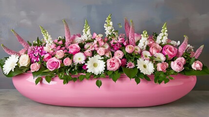  a large pink vase filled with lots of pink and white flowers on top of a table next to a gray wall.