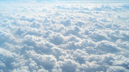  a view of the sky from an airplane window with a lot of clouds in the foreground and a bright blue sky in the background.