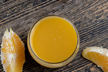 peeled juicy oranges and orange juice on the table © rsooll