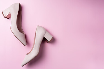 Women's shoes on a pink background. Space for text