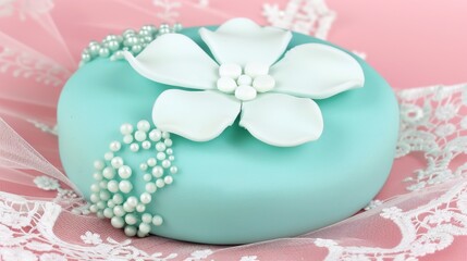  a blue cake with white flowers and pearls on a lace doily on a pink and white lace tablecloth. - obrazy, fototapety, plakaty