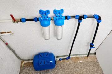 Utility room which water bladder tank and purification filters for cold drinking water of domestic water supply system. - obrazy, fototapety, plakaty