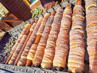 Process of baking trdelnik in Prague, Grilled rolled dough topped with sugar