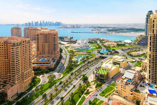 View of the modern Doha skyline with the Doha Pearl island and Sheikh Hamad bin Jassim Mosque in view along the Persian Gulf. 