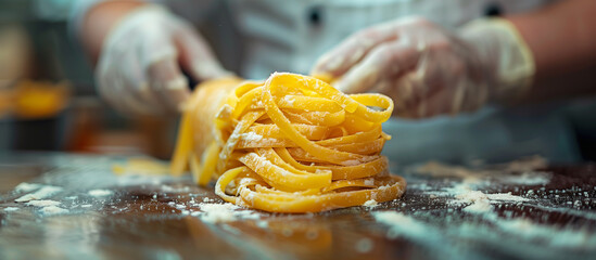 Chef making fresh egg pasta dough at restaurant. Italian food.