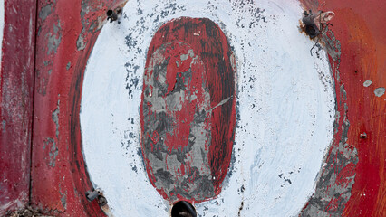 rusty white letter o on red background 