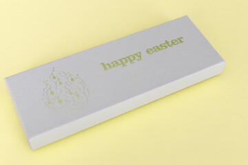 A box of chocolate eggs with the inscription in English Happy Easter.