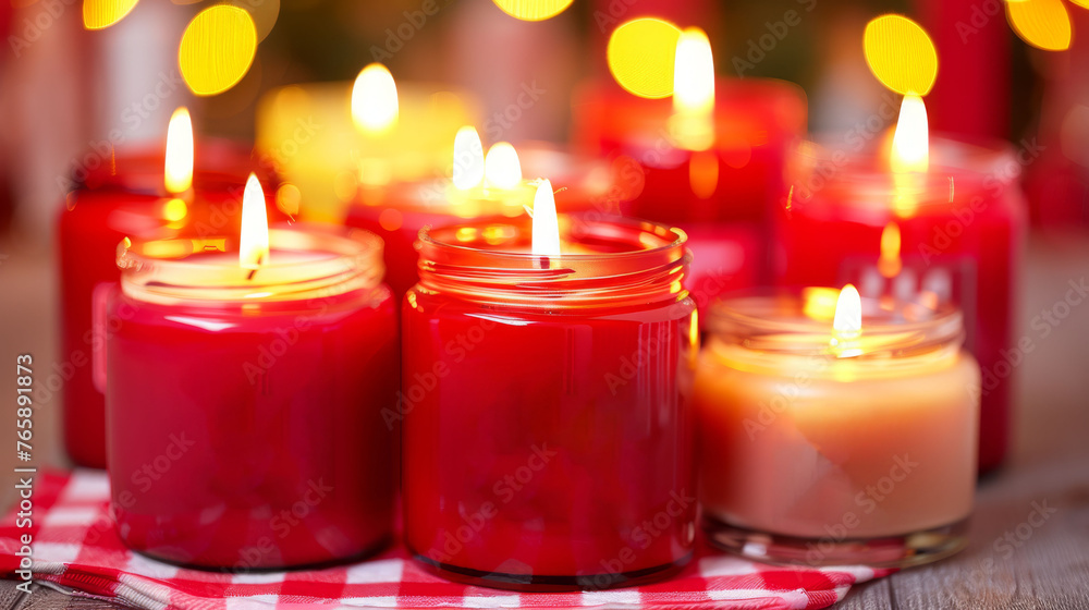 Poster a group of red candles sitting on top of a red and white checkered table cloth next to each other.