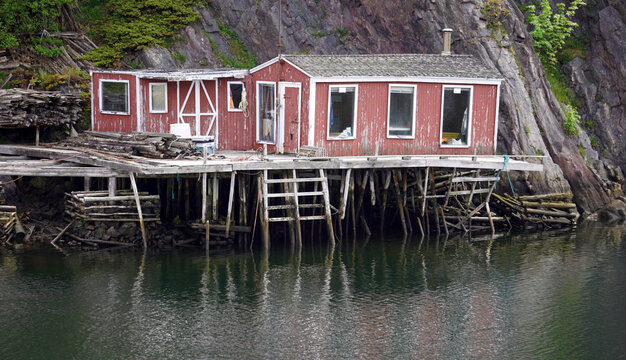 Tumbledown wooden house on stilts on the side of a cliff in St John's, Newfoundland