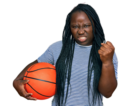 Young black woman with braids holding basketball ball annoyed and frustrated shouting with anger, yelling crazy with anger and hand raised