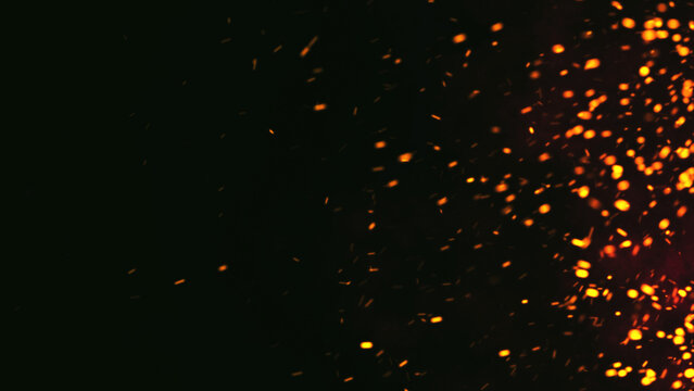 Dark Glitter Fire Lights Rise Through Smoke, Fog, and Misty Texture Over Black Background, Burning Sparks in this Abstract Composition, Red Glowing Ember Particles.