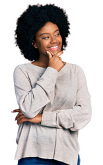 Young african american woman wearing casual clothes with hand on chin thinking about question, pensive expression. smiling with thoughtful face. doubt concept.