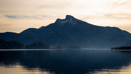 Sunset over a giant mountain and a flying eagle over a lake