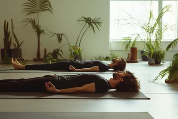 Foto auf Acrylglas men lying on yoga mats in meditation position in yoga school © Marta