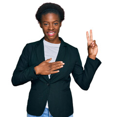 Young african american girl wearing business clothes smiling swearing with hand on chest and...