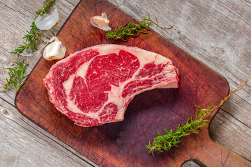 Close-Up 4K Ultra HD Image of Raw Ribeye Steak with Herbs - Stock Photography