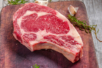 Close-Up 4K Ultra HD Image of Raw Ribeye Steak with Herbs - Stock Photography