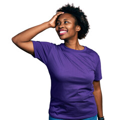 African american woman with afro hair wearing casual purple t shirt smiling confident touching hair...