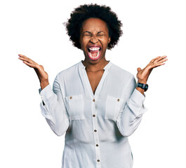 African american woman with afro hair wearing casual white t shirt celebrating mad and crazy for...