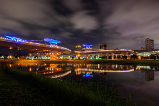 Amazing night scenery and reflections in an early summer evening near the Sanchong Station of Taoyuan Airport MRT in the New Taipei City Metropolitan Park.