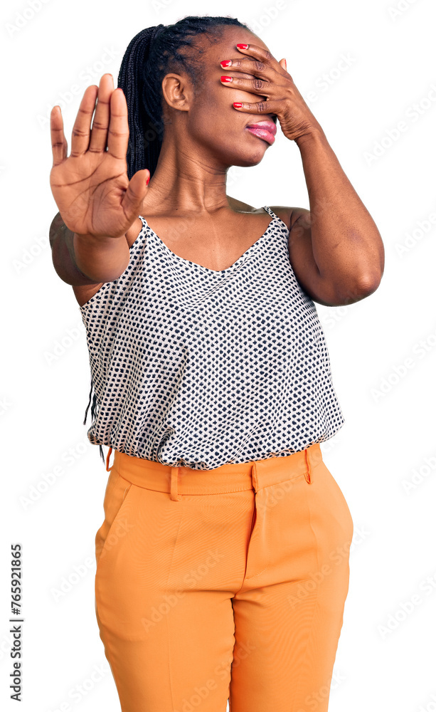 Wall mural young african american woman wearing casual clothes covering eyes with hands and doing stop gesture 